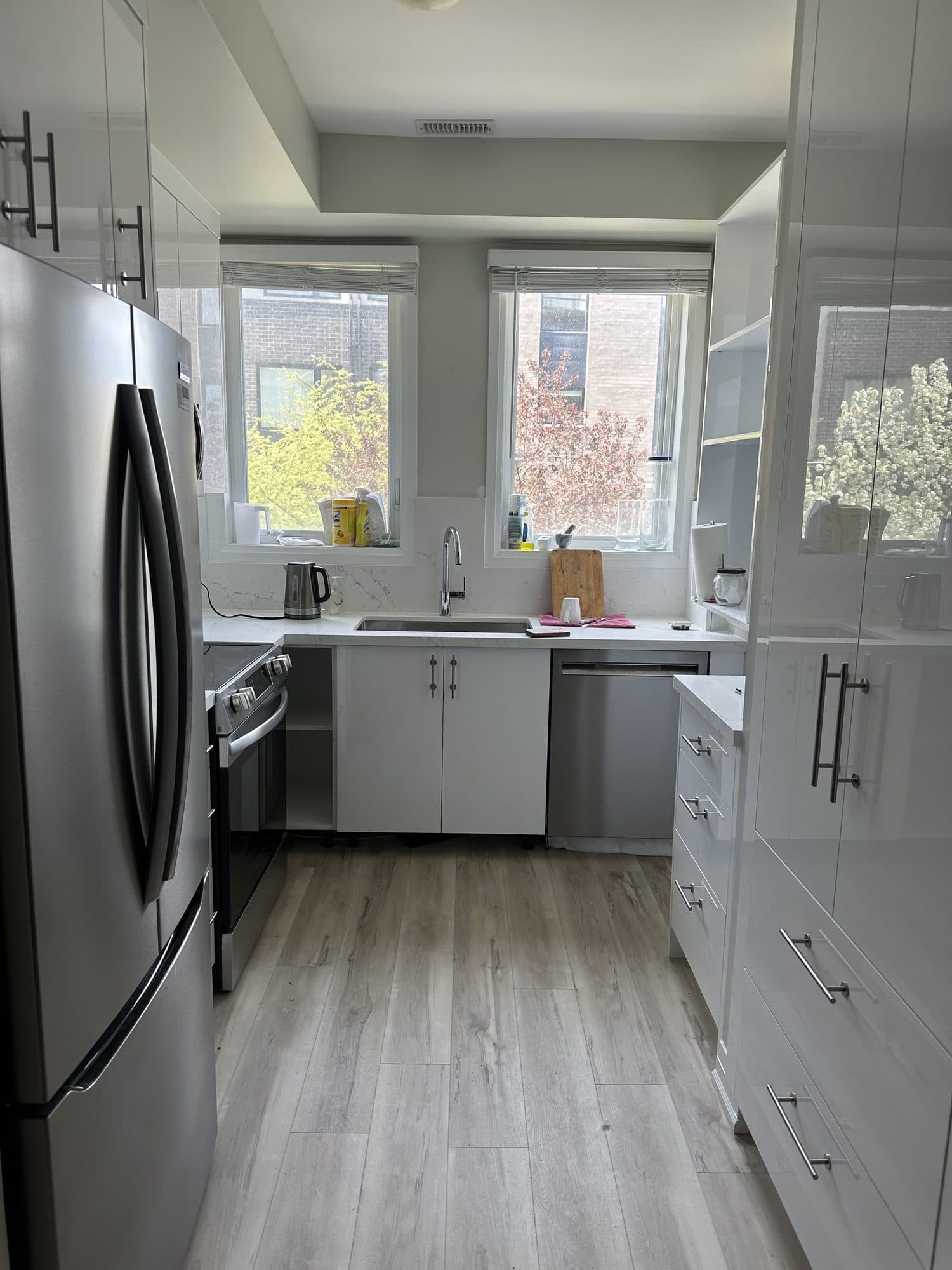 The same kitchen finished with gloss cabinetry and a quartz island