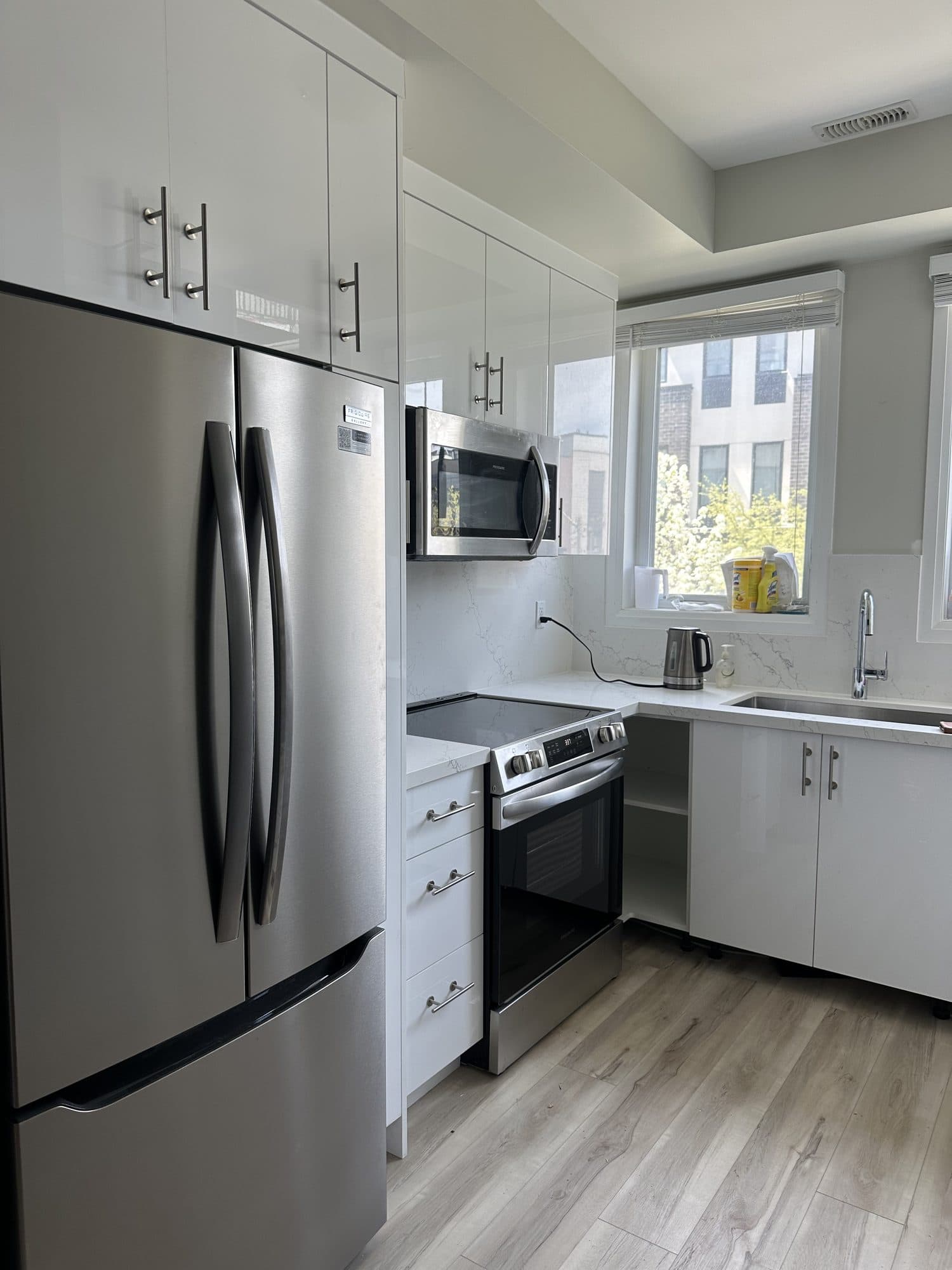 The same kitchen renewed with white cabinetry and quartz counters