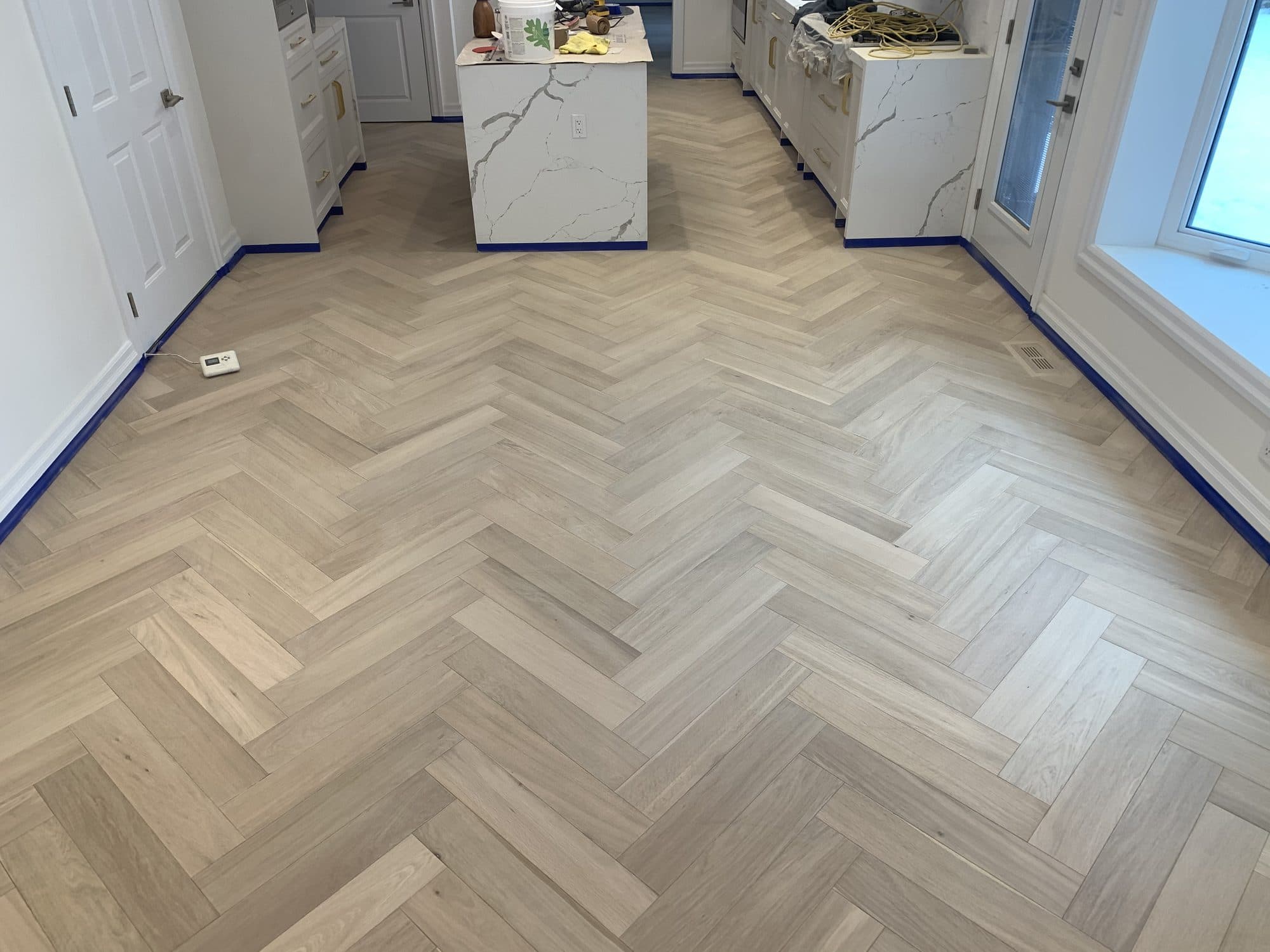 Herringbone hardwood flooring installed by Woodstellar