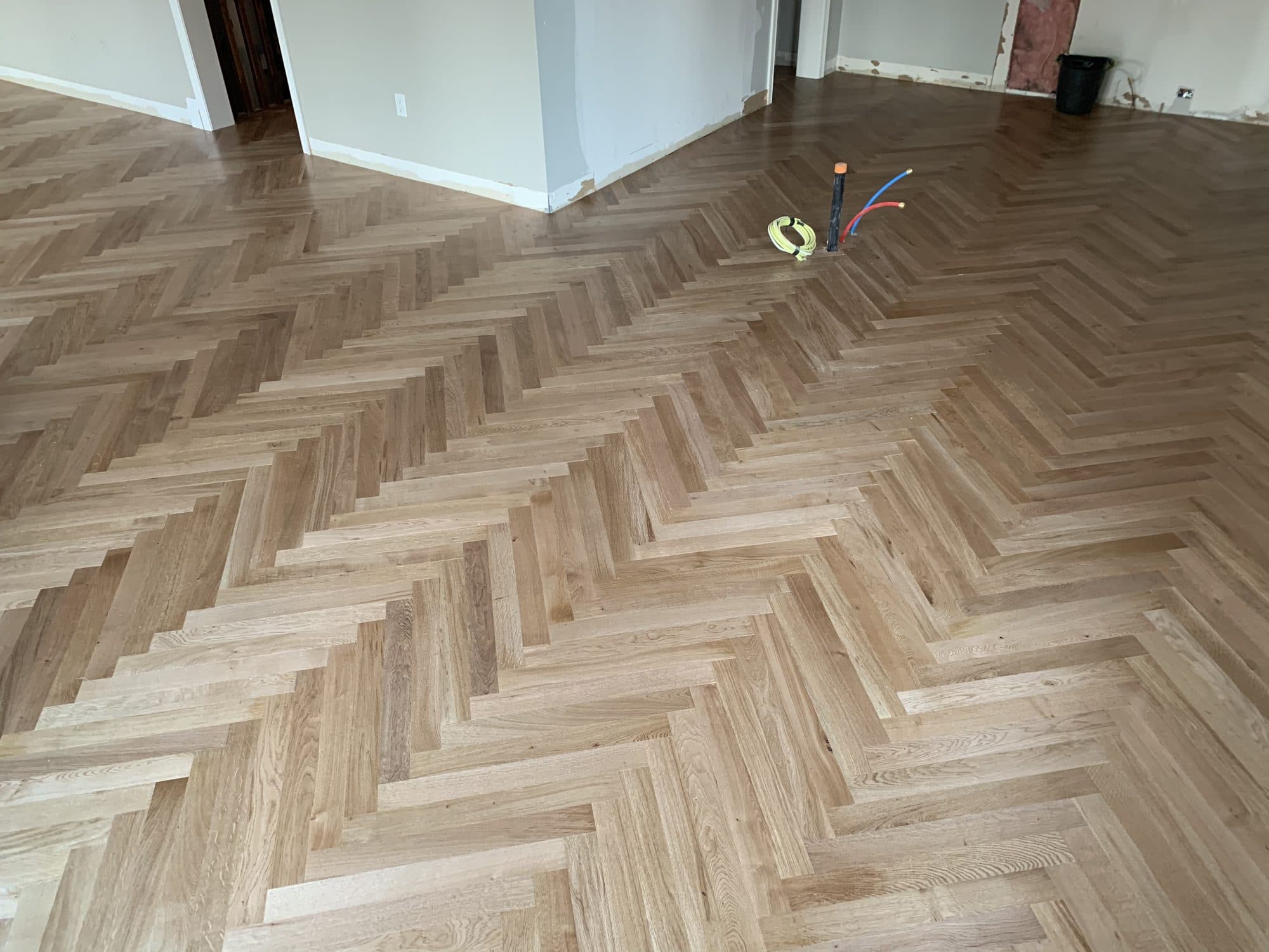 Herringbone hardwood flooring installed by Woodstellar