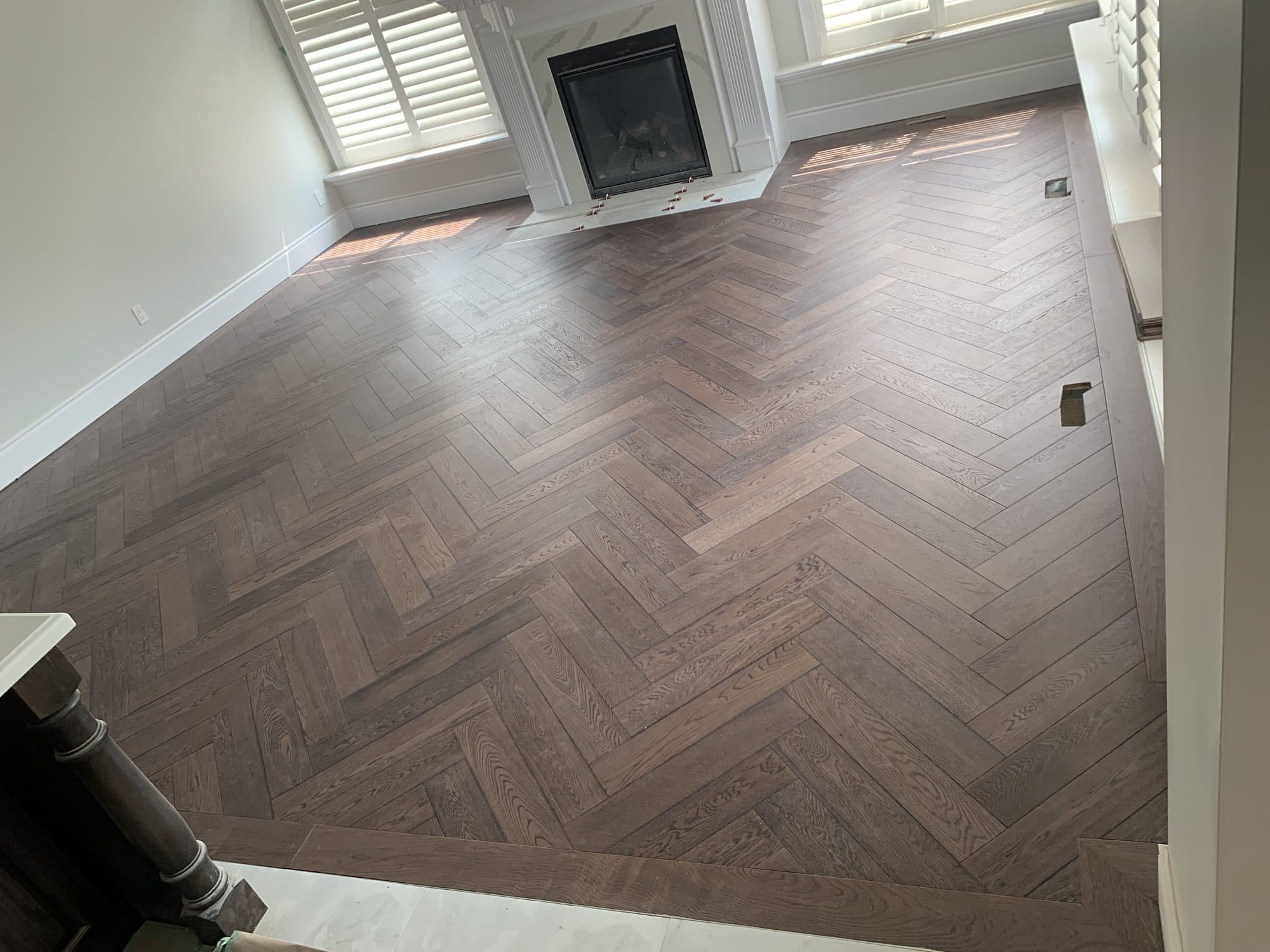 Herringbone hardwood flooring installed by Woodstellar