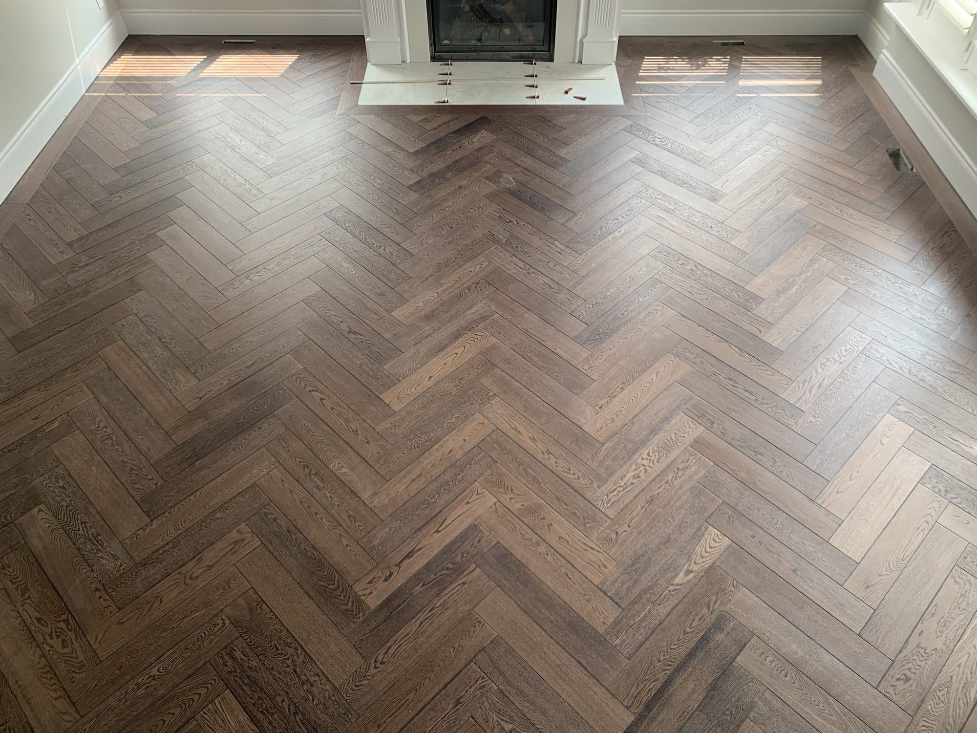 Herringbone hardwood flooring installed by Woodstellar