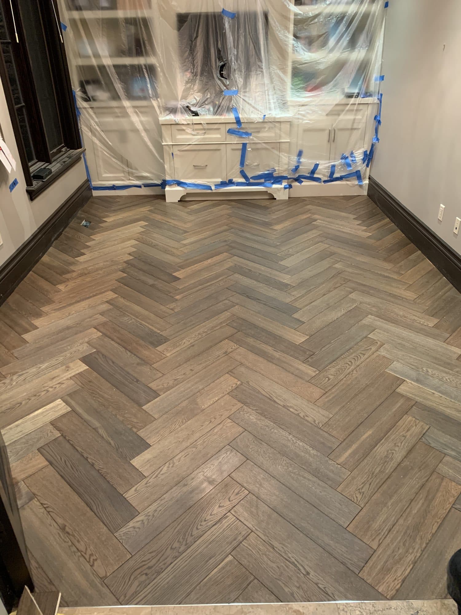 Herringbone hardwood flooring installed by Woodstellar