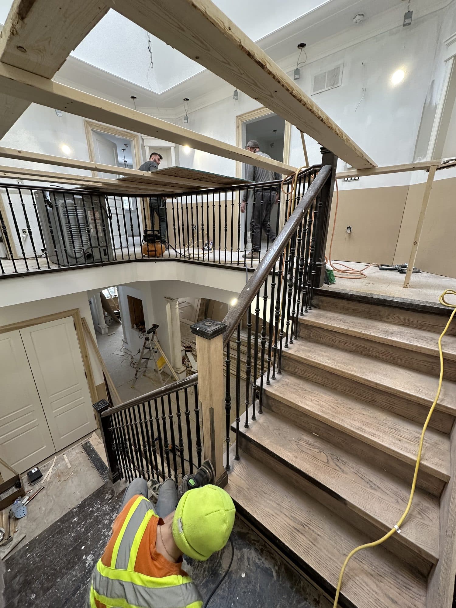 A craftsman working on the staircase during the build