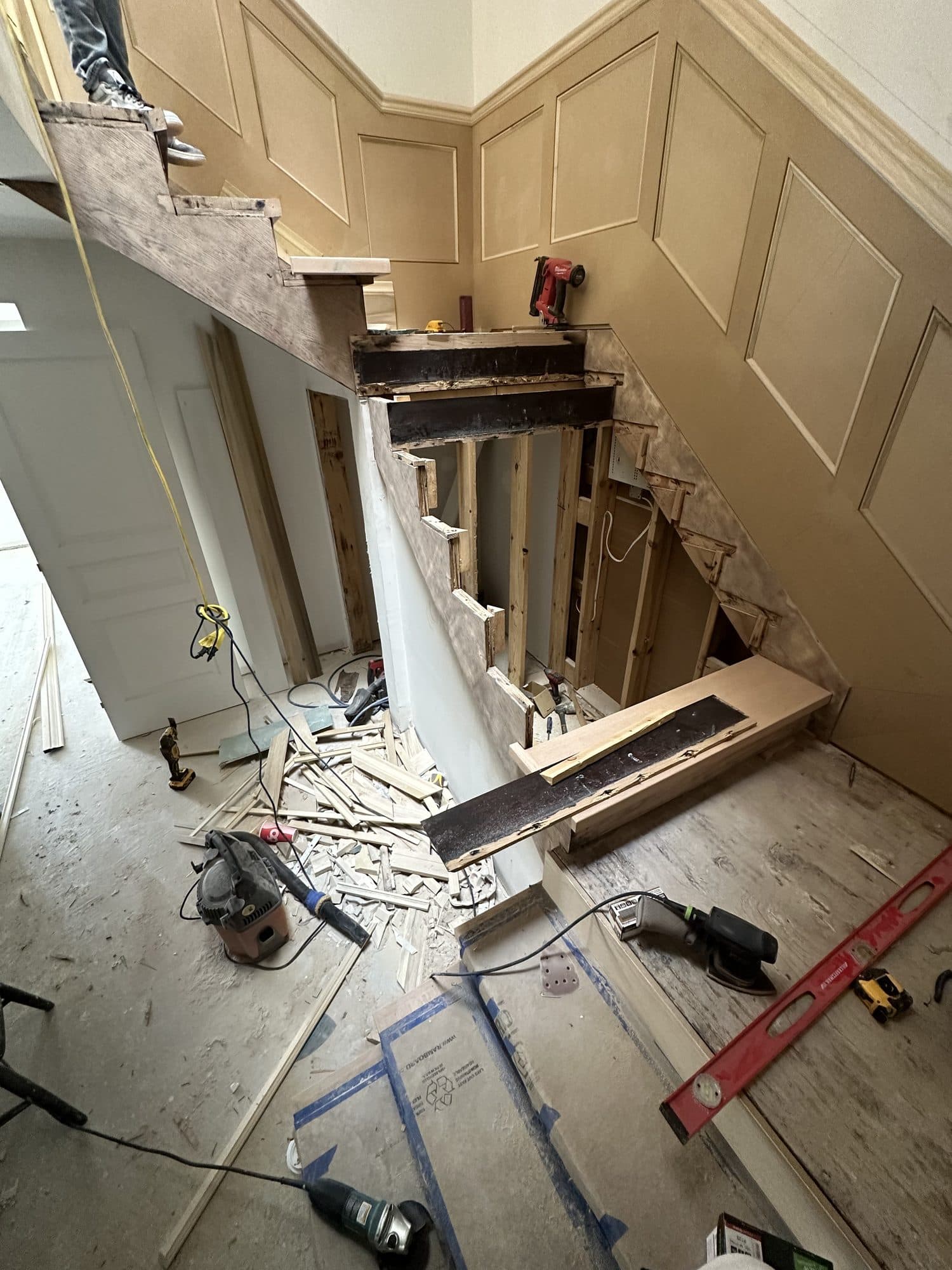 The staircase being rebuilt over panelled walls
