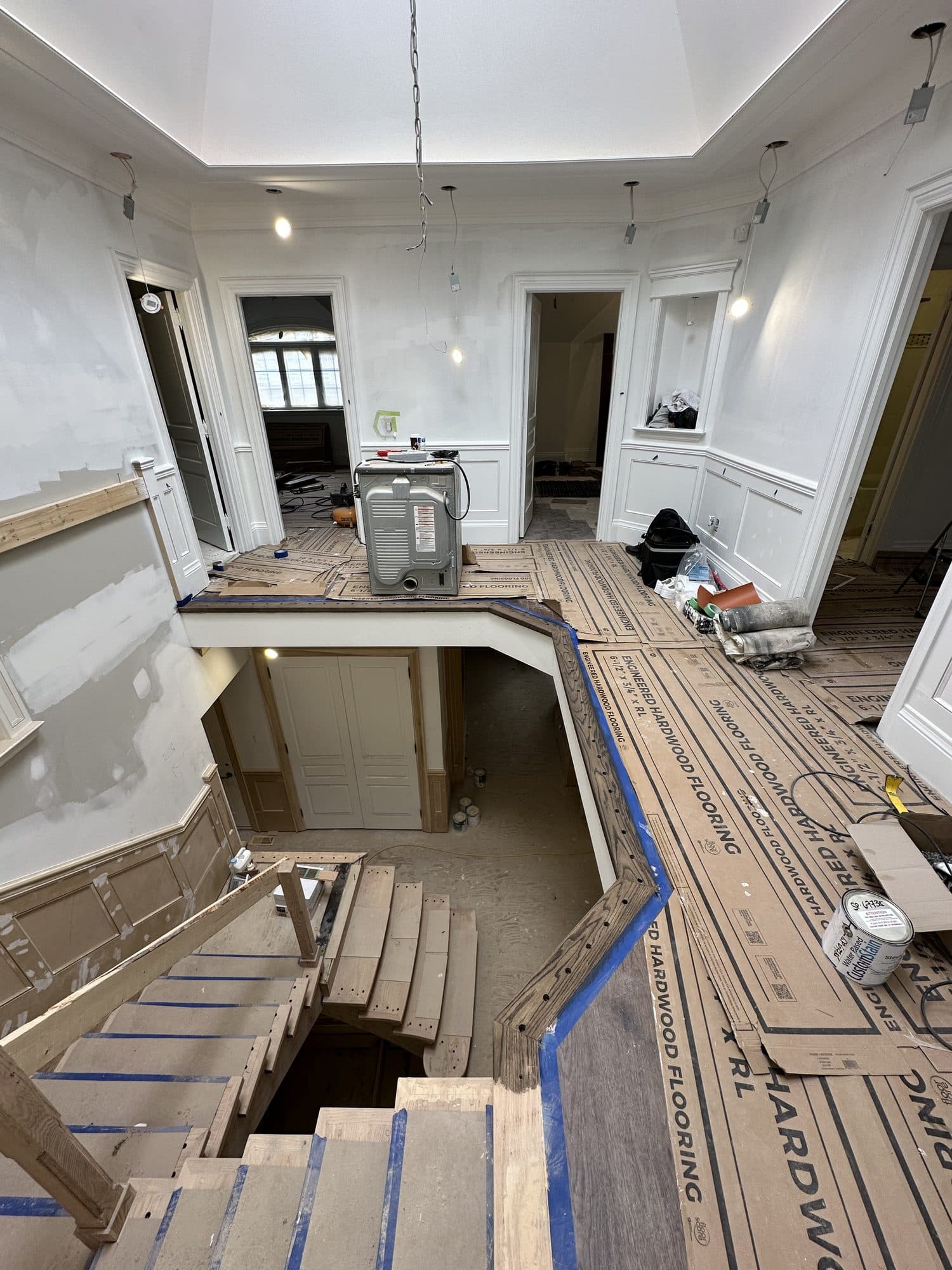 Engineered hardwood flooring being laid across the upper hall