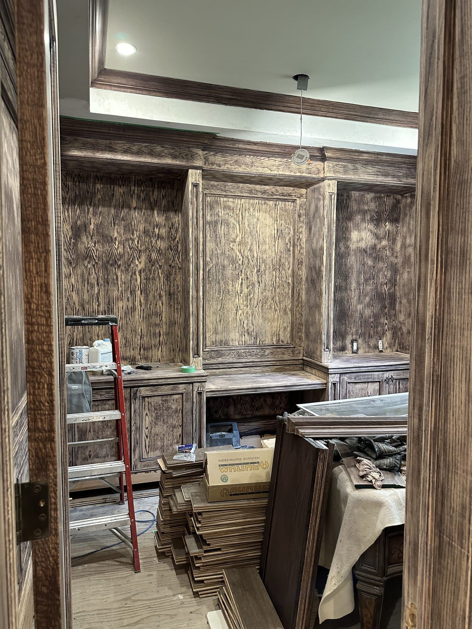 A study being panelled in dark walnut during the build