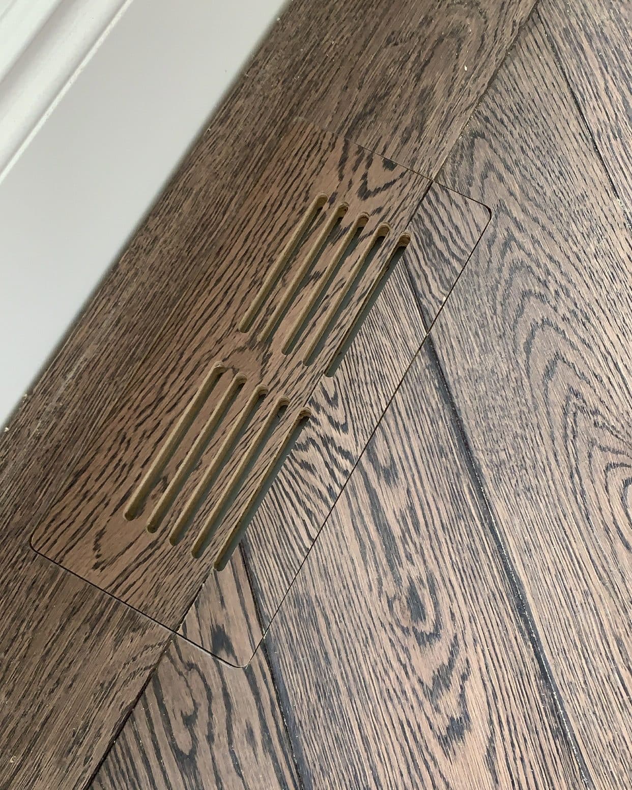 A seamless custom hardwood floor vent by Woodstellar