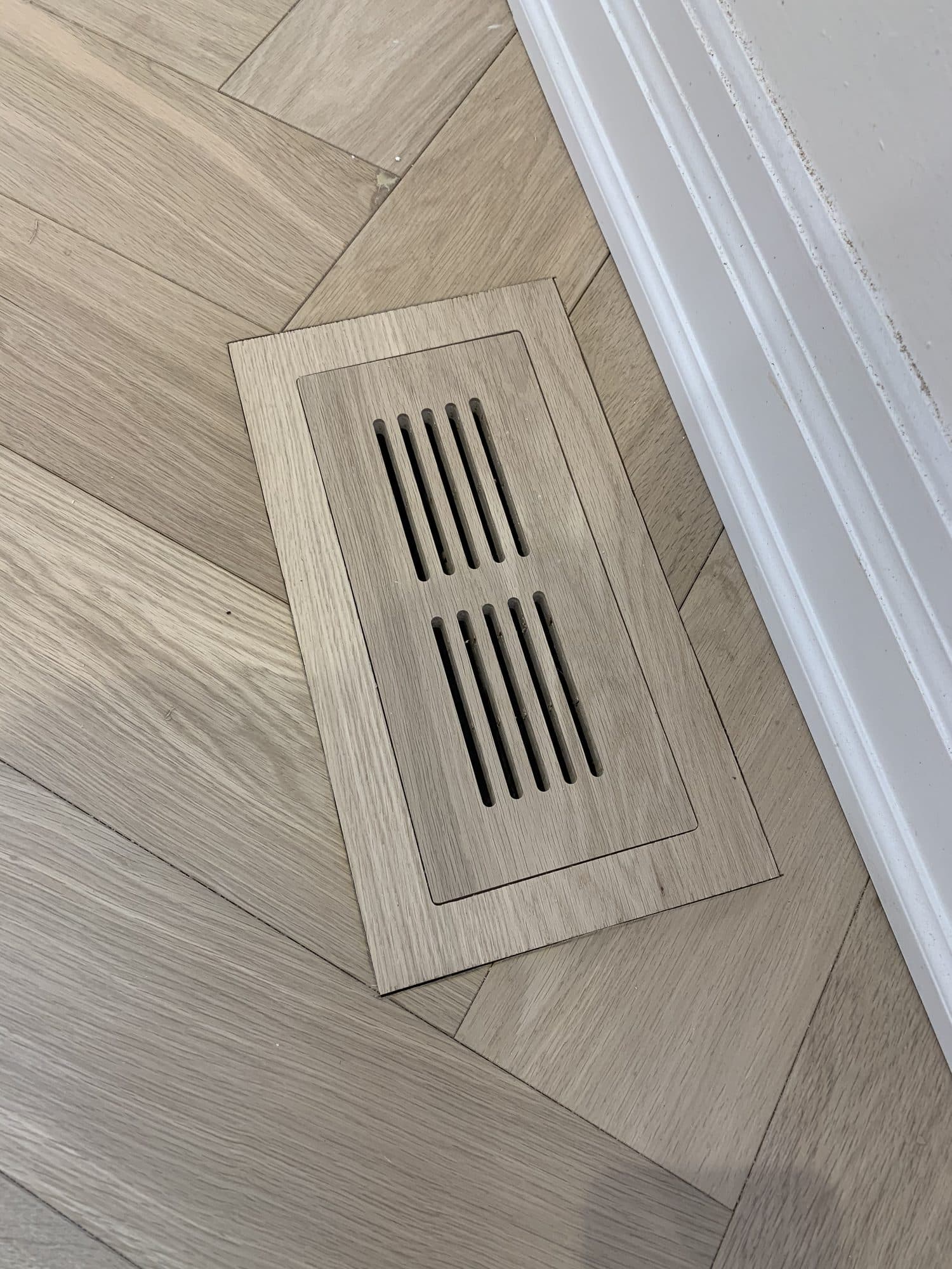 A seamless custom hardwood floor vent by Woodstellar