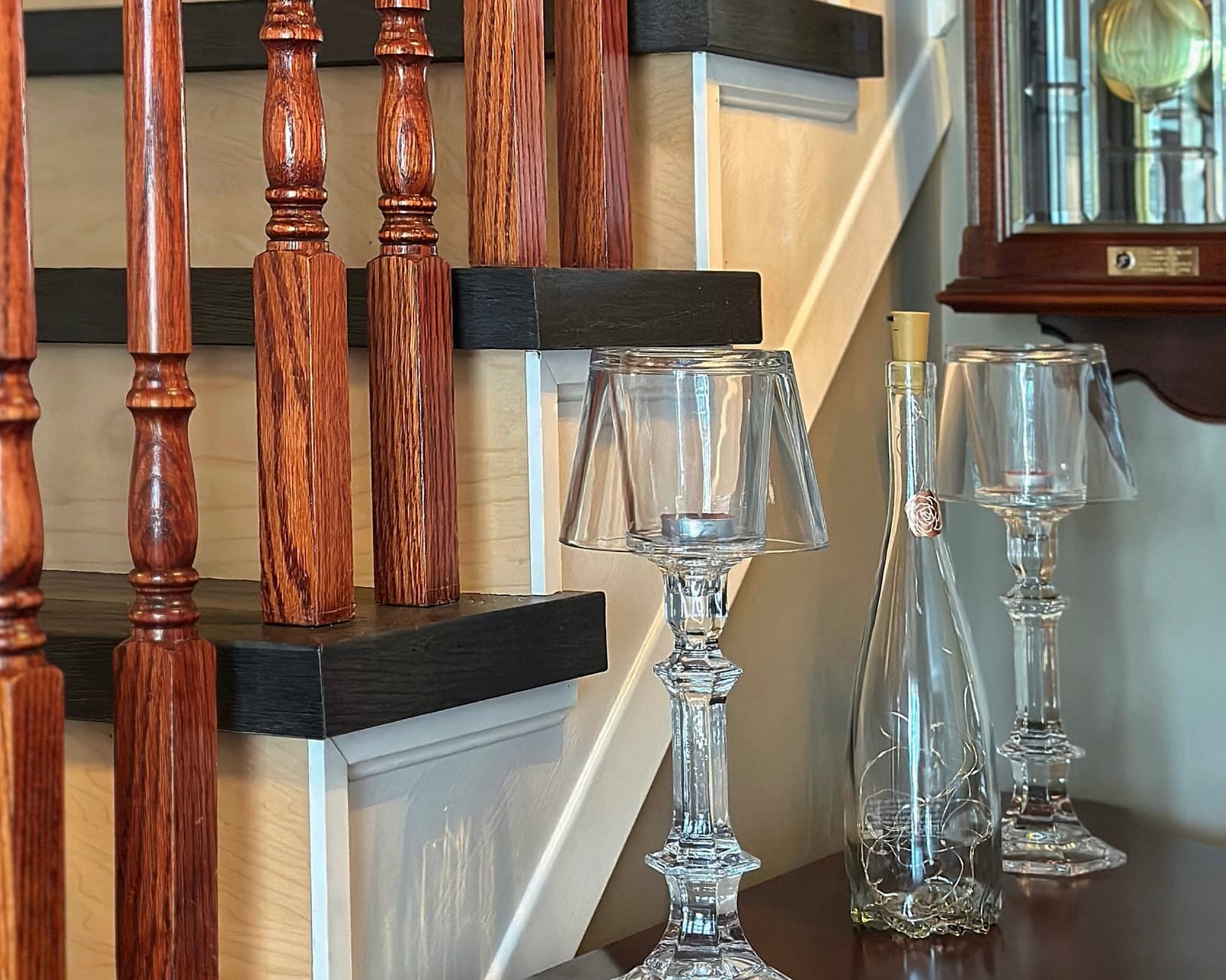 Detail of a turned oak newel post and railing beside a console table