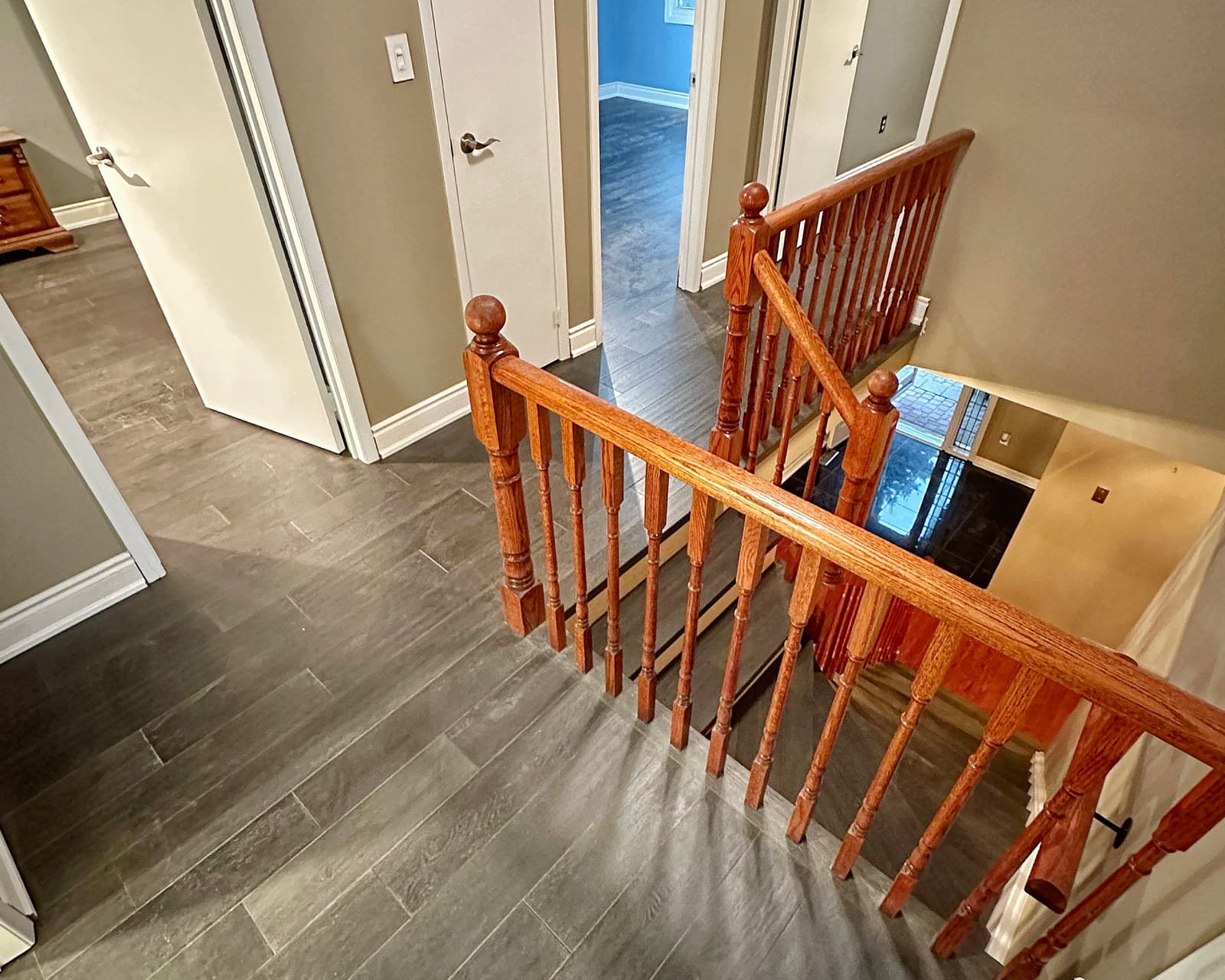 A refinished staircase and hardwood landing seen from above