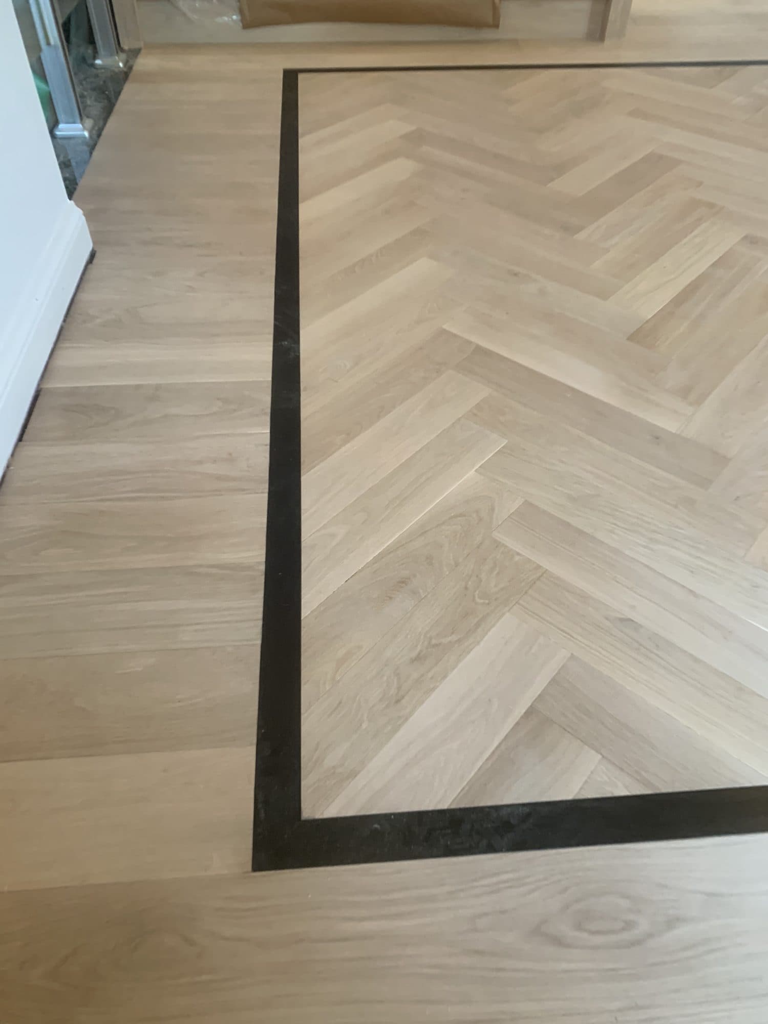 Herringbone hardwood flooring installed by Woodstellar