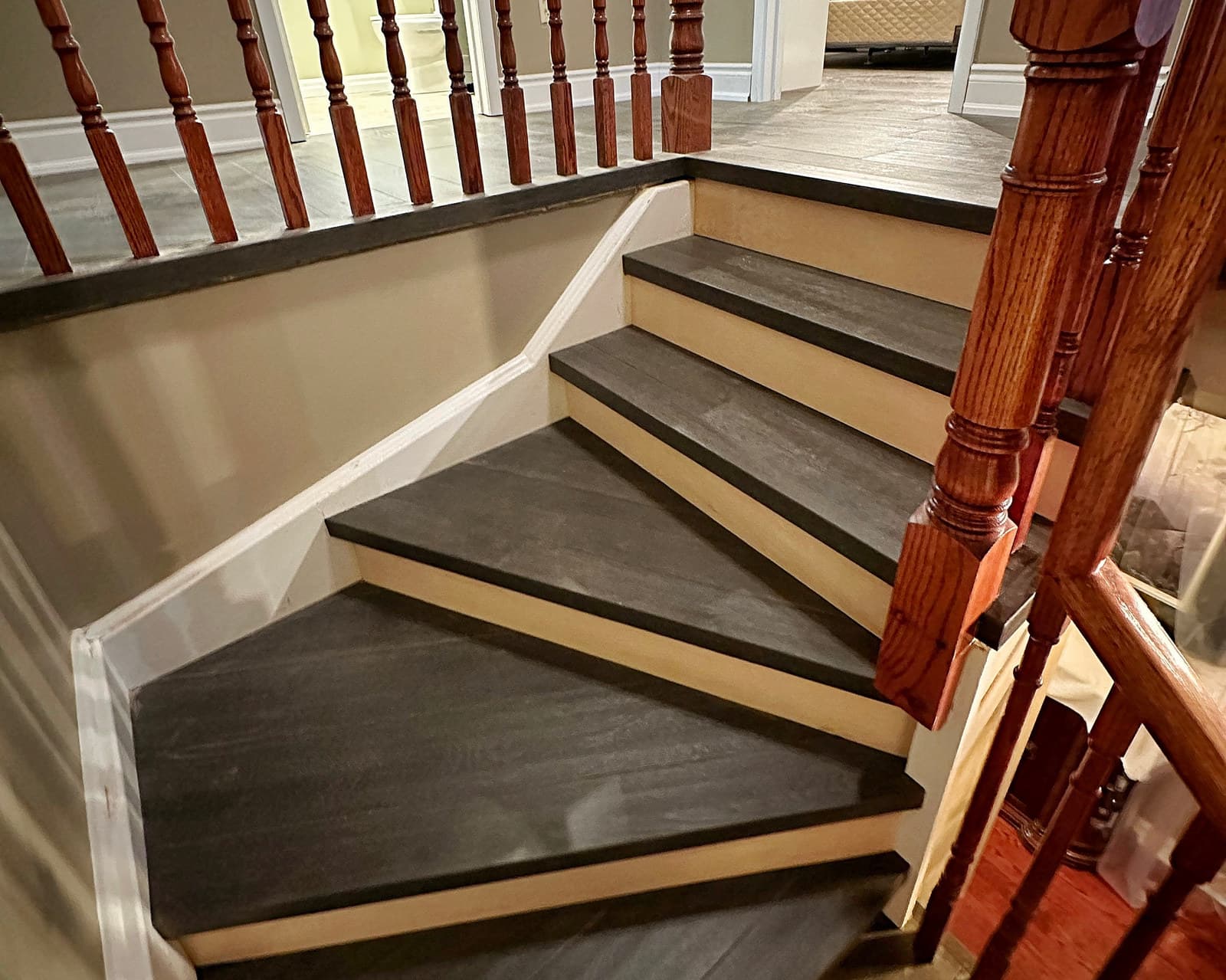 An oak staircase with dark-stained treads and crisp white risers